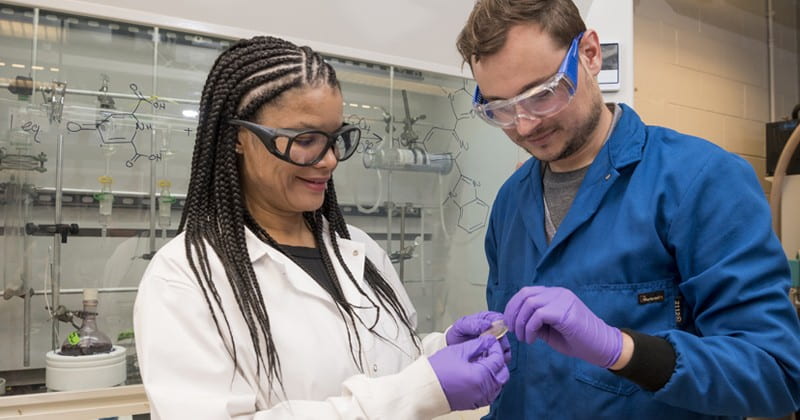 LaShanda Korley (left) and Chase Thompson examine a sample of the material they studied.
